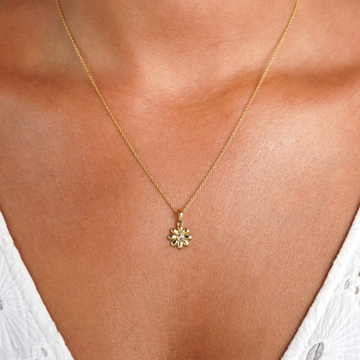 Gold necklace with flower and Rose quartz crystal. Beautiful crystal necklace with Rose quartz in a sweet flower.