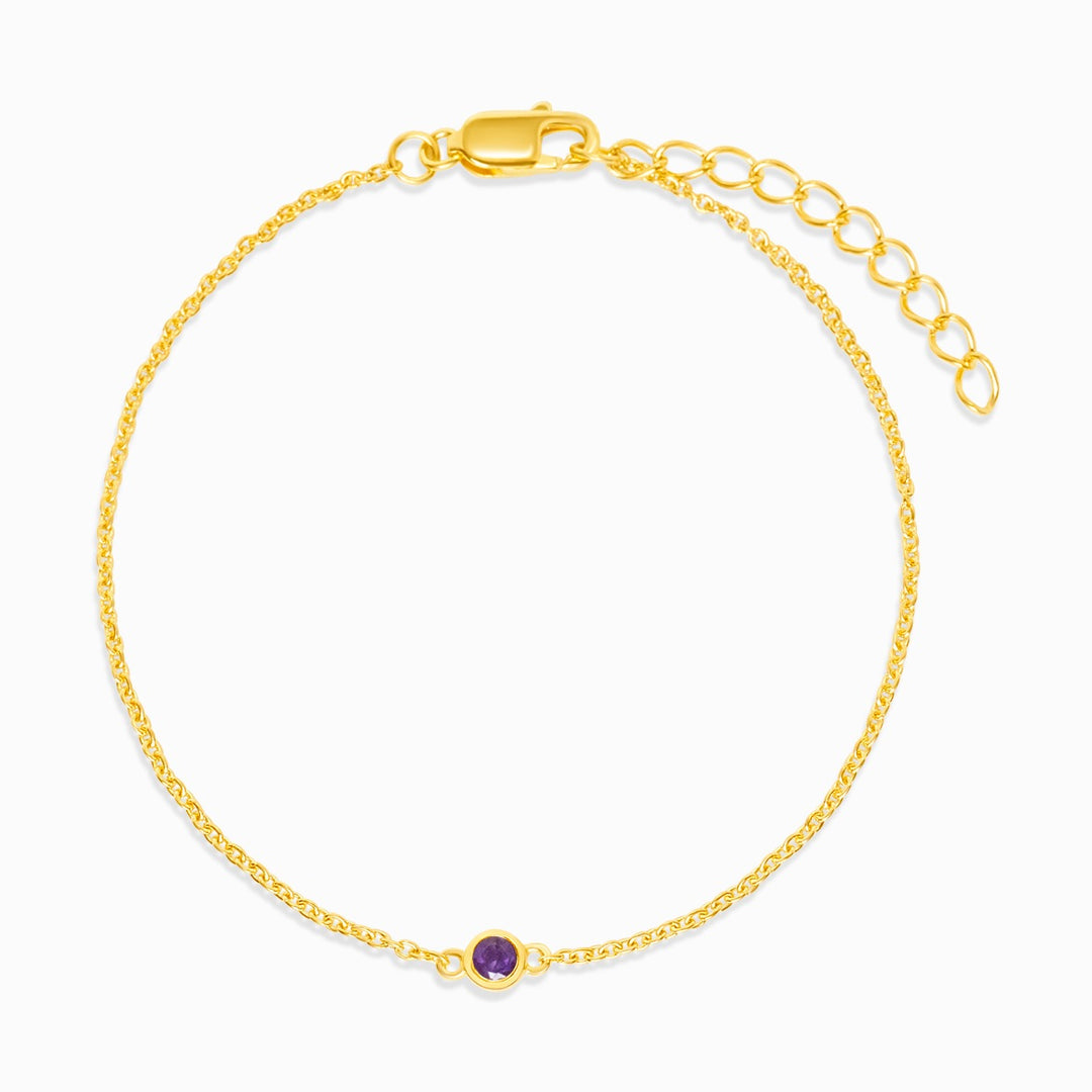 Gold bracelet with purple Amethyst which is February's birthstone. Jewelery with Amethyst crystal to wear as a bracelet in gold.