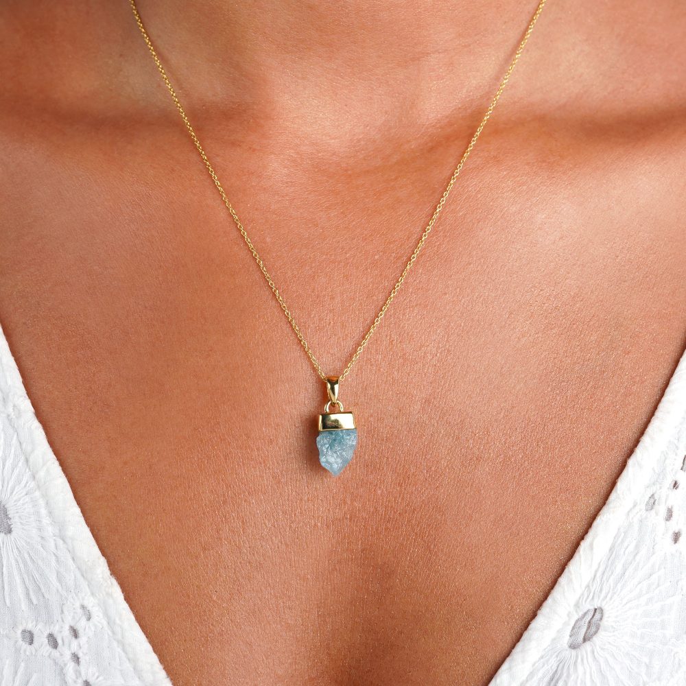 Raw Aquamarine necklace in gold. Gemstone necklace with a blue raw Aquamarine crystal.