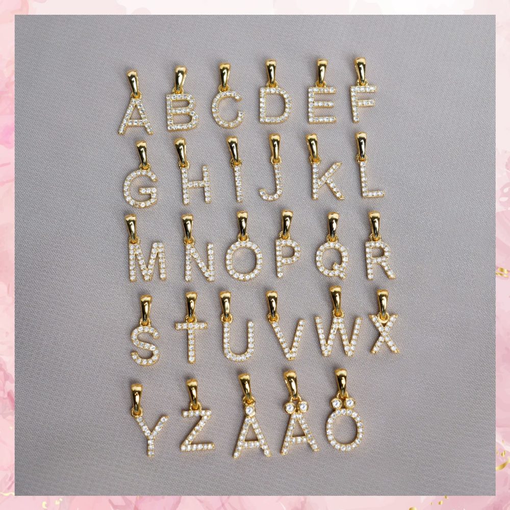 Letter jewelry collection in gold. Letter charms in gold filled with real crystals.