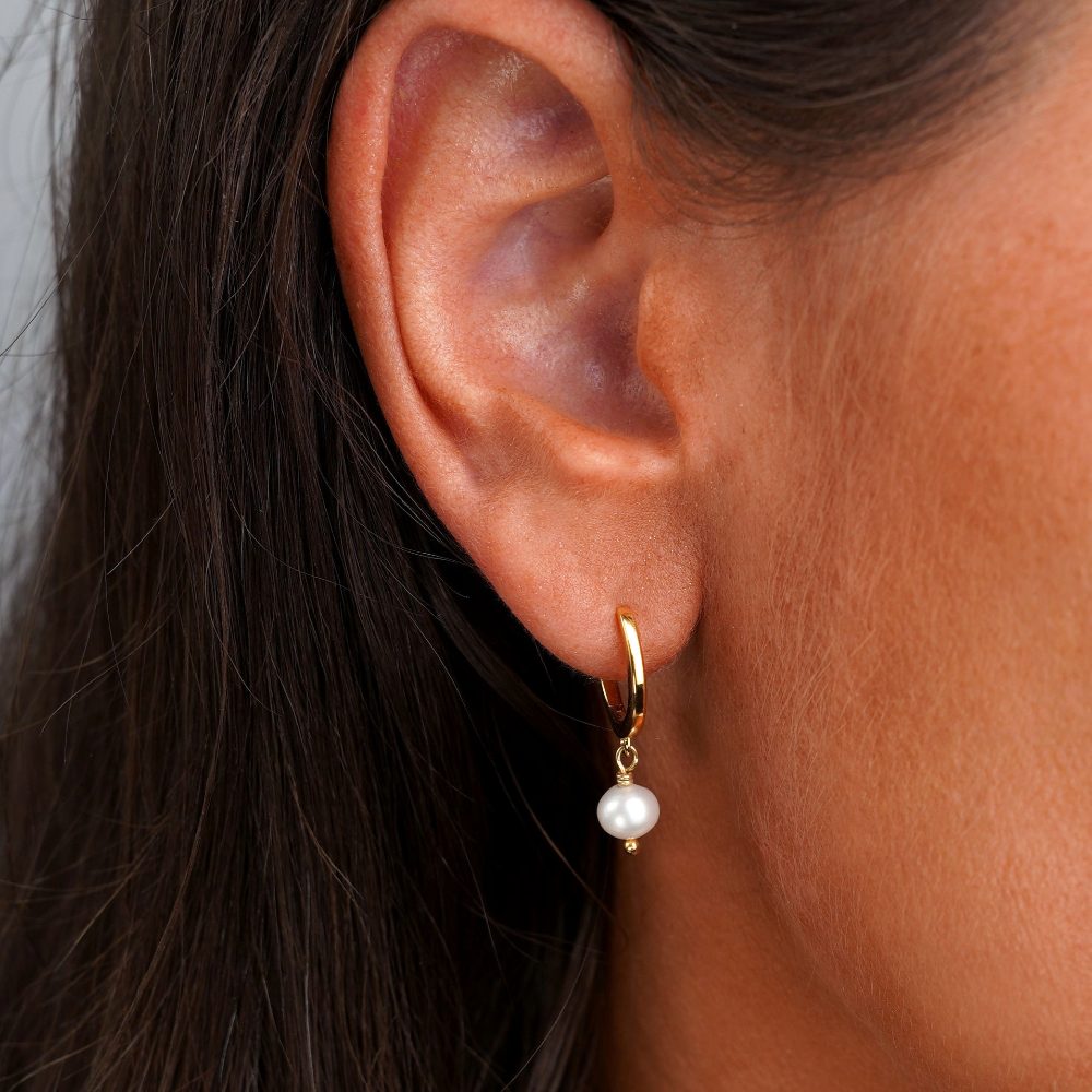 Luxurious hoop earrings with freshwater pearl. Earrings with freshwater pearl in gold.