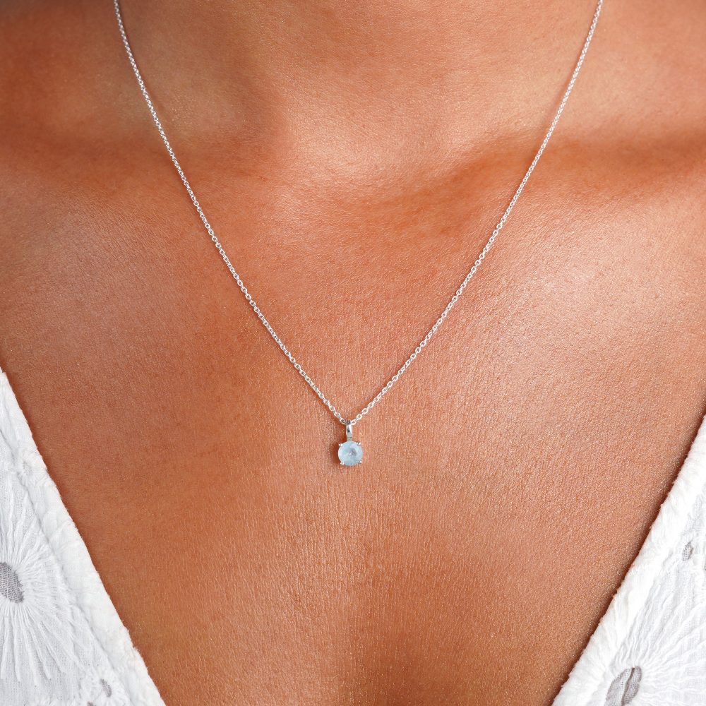 Silver necklace with small crystal charm of Aquamarine. Crystal jewelry in a classy design with blue aquamarine