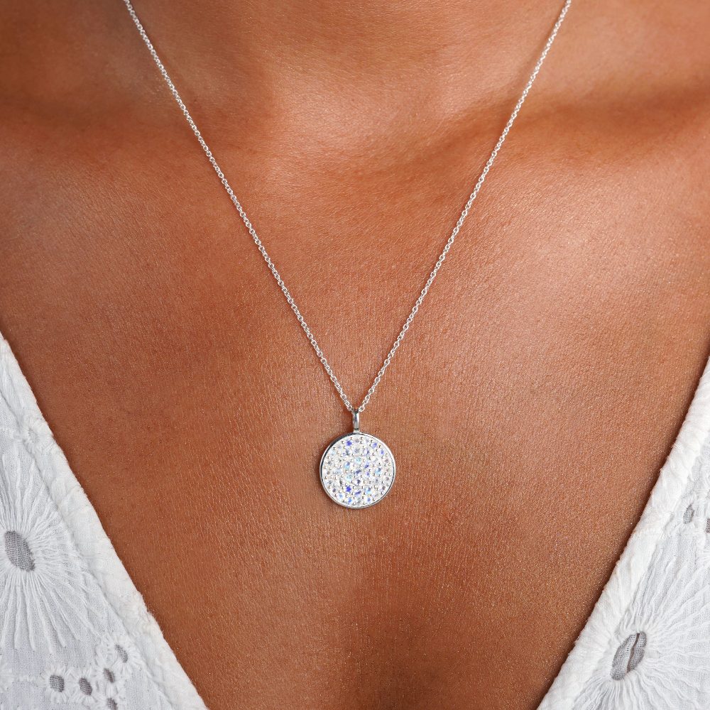 Silver coin with lots of Rainbow Moonstone crystals to wear as a necklace. Crystal necklace with Moonstone in silver, also is the birthstone of June