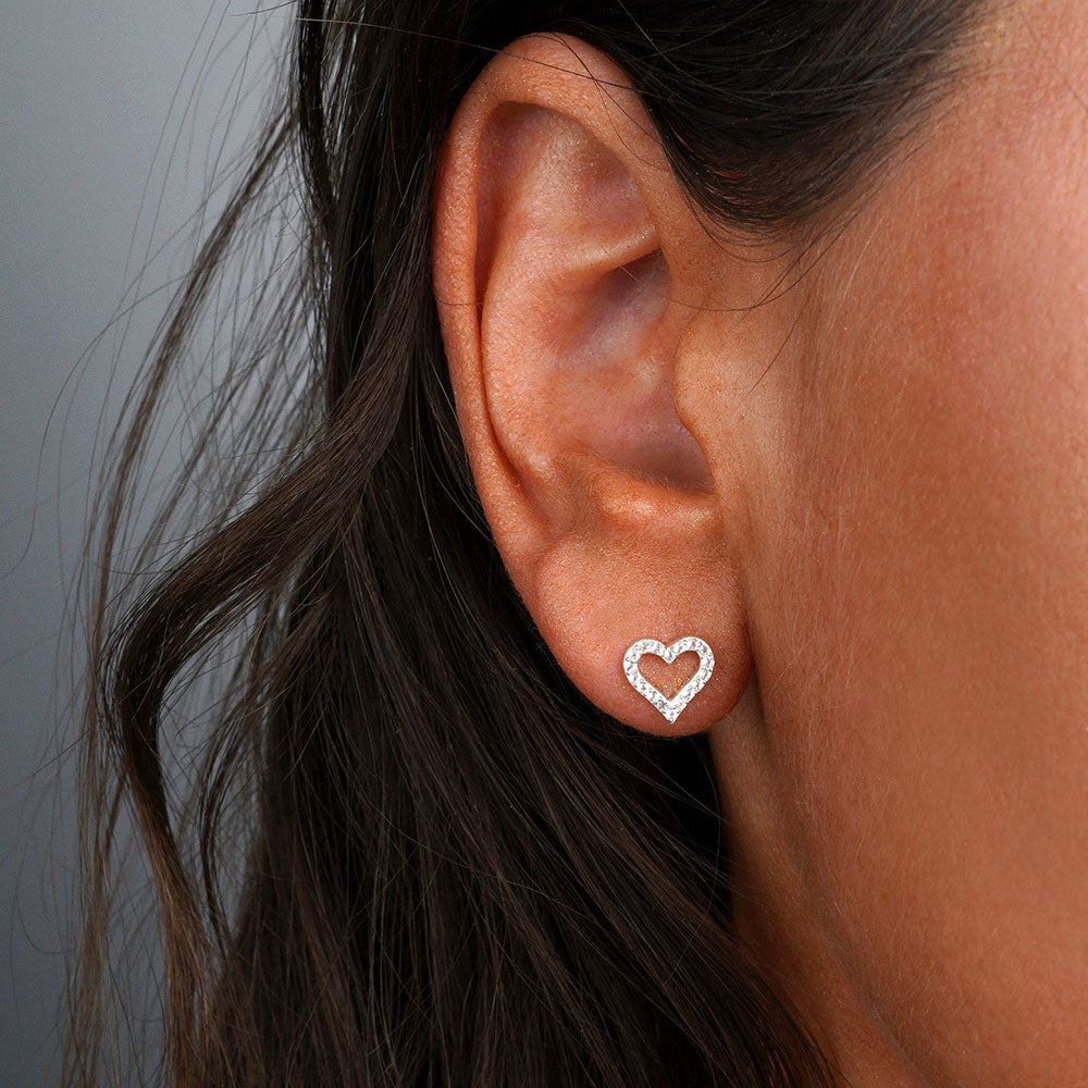 Heart earrings with white topaz crystals in silver. Stud earrings with sparkly hearts made of real crystals.