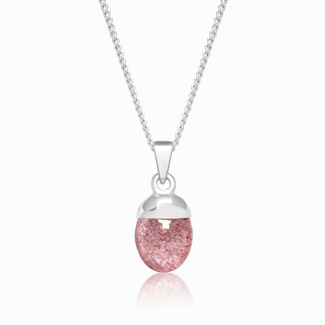 Tumbled strawberry quartz crystal in silver to wear in a necklace. Jewelry with the Strawberry Quartz crystal has a red rose color.