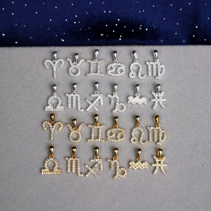 Crystal charms with zodiac signs. White Topaz jewelry with zodiac signs in silver and gold.