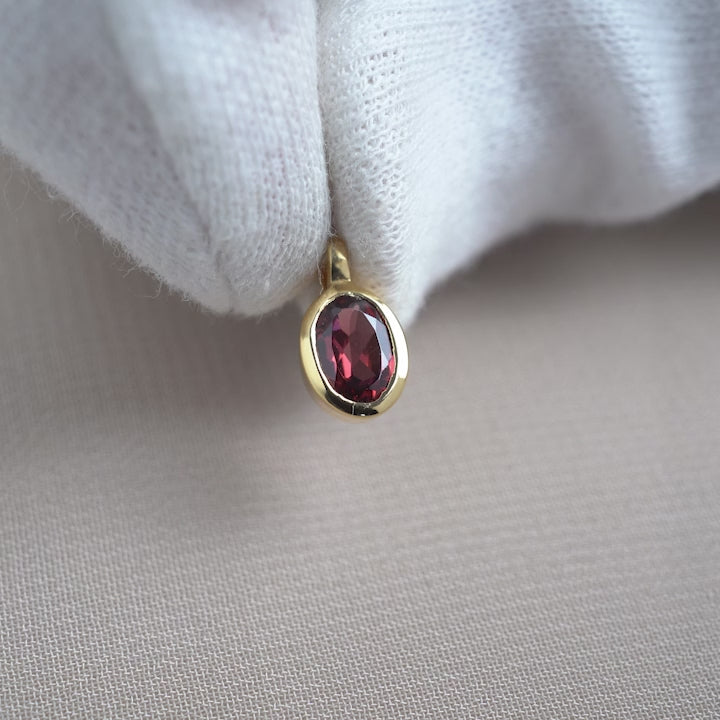 Crystal charm with red gemstone Garner in gold. Garnet charm in gold in high quality.