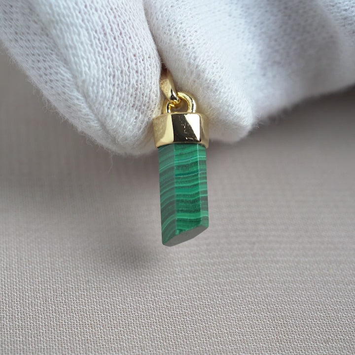 Gemstone pendant with Malachite that has a green color. Beautiful crystal pendant with gemstone Malachite with gold details.