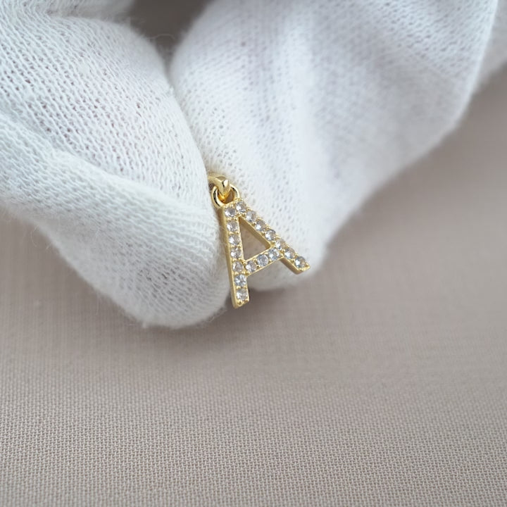Letter charm in gold filled with sparkly crystals. Gemstone charm with letter A in gold.