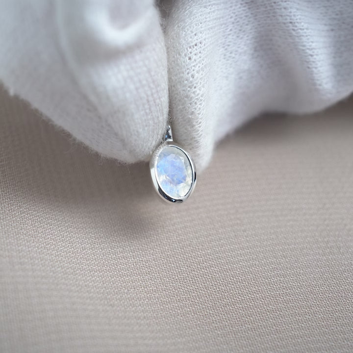 Moonstone charm in silver that has a beautiful blue shimmer. Gemstone charm in silver with Rainbow Moonstone crystal.
