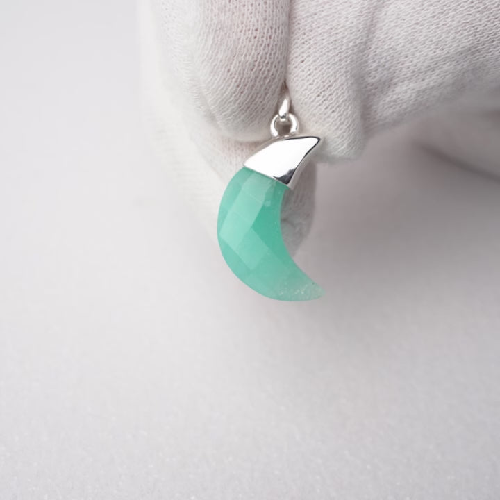 Moon shaped Amazonite gemstone pendant with silver details. Amazonite pendant in moon shape with silver details.