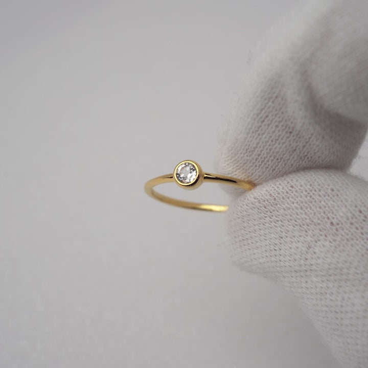 Gold ring with White Topaz gemstone that resembles a diamond.
