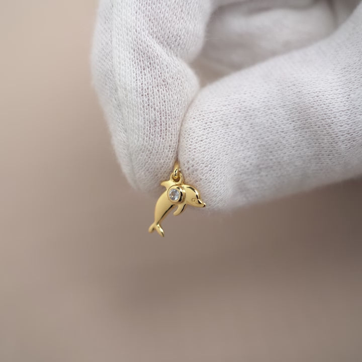 Gold charm with dolphin and Aquamarine crystal. Crystal charm in gold and blue gemstone Aquamarine.
