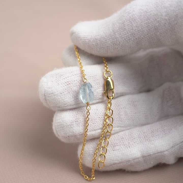 Gold bracelet with raw gemstone Aquamarine.