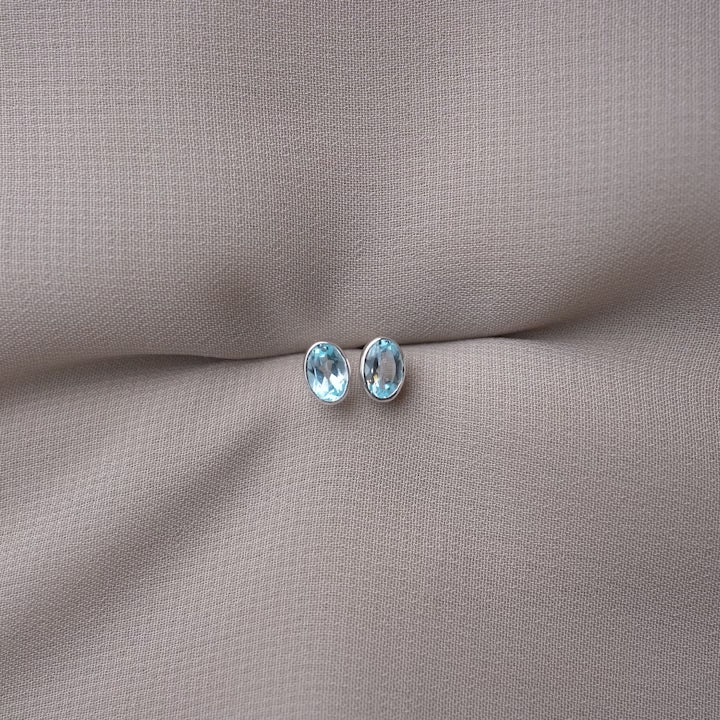 Silver earrings with Blue Topaz crystal also the birthstone of December. Crystal stud earrings with Blue Topaz in a modern and classy design.