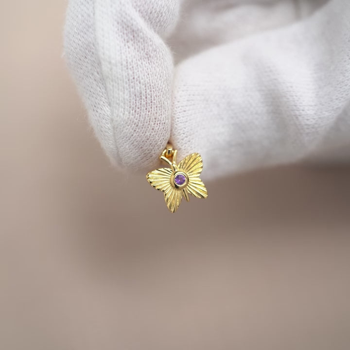 Gemstone charm with purple crystal Amethyst in a golden butterfly. Amethyst jewelry with a butterfly in gold. 