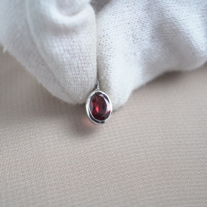 Birthstone charm in silver with red gemstone Garnet. Crystal charm with Garnet the birthstone of January.