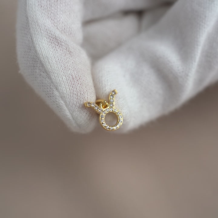 Crystal charm with Taurus sign in gold. Zodiac pendant in gold with White Topaz crystals. 