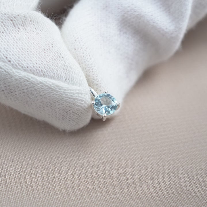 Sterling Silver charm with Blue Topaz crystal. Gemstone jewelry with Blue Topaz charm, also the birthstone of December.