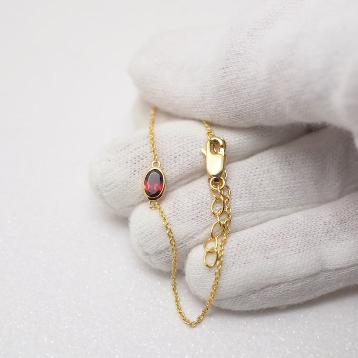 Birthstone bracelet in gold for January. Gemstone bracelet with red gemstone Garnet in gold.