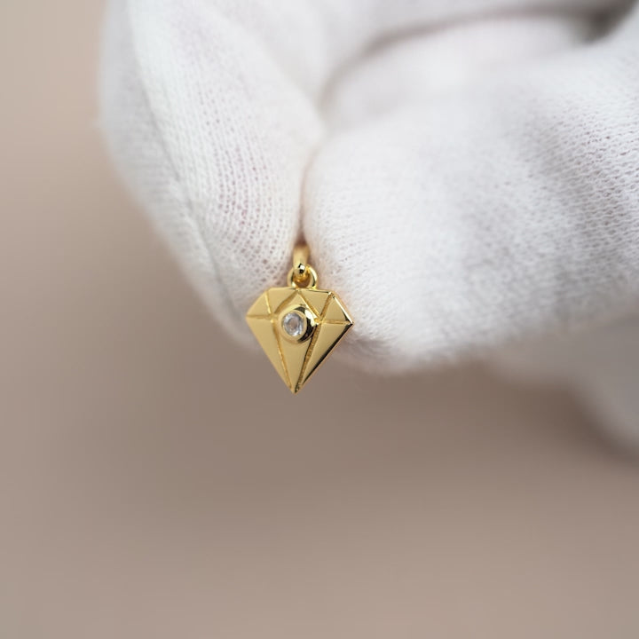 Clear Quartz charm in gold and a diamond design. Gemstone charm in gold with a diamond and a Clear Quartz crystal in it.