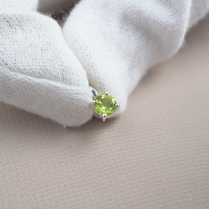Peridot charm in silver. Crystal jewelry with a green crystal Peridot in silver.