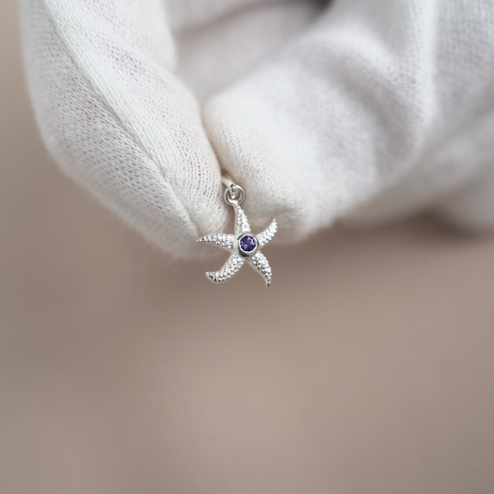 Starfish pendant in sterling silver and September birthstone Iolite. Crystal jewelry charm with a starfish and gemstone Iolite in silver.