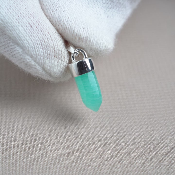 Amazonite pendant formed as a mini point with silver details. Gemstone pendant with turquoise Amazonite crystal.