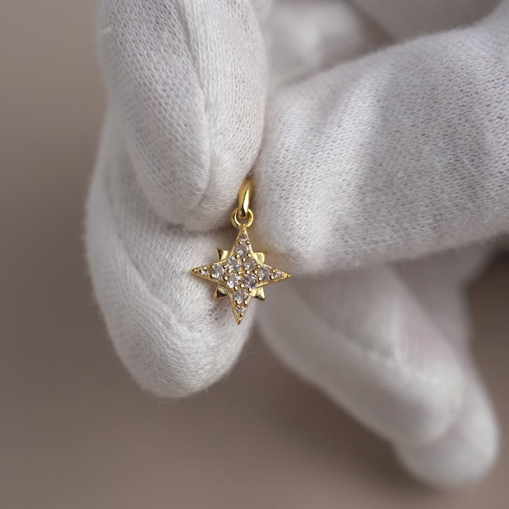 Star charm in gold and with White Topaz crystals.