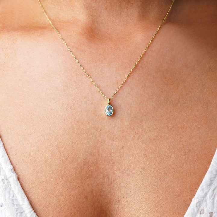 Blue Topaz gemstone necklace in gold. Crystal jewelry with Blue Topaz, which is December birthstone.