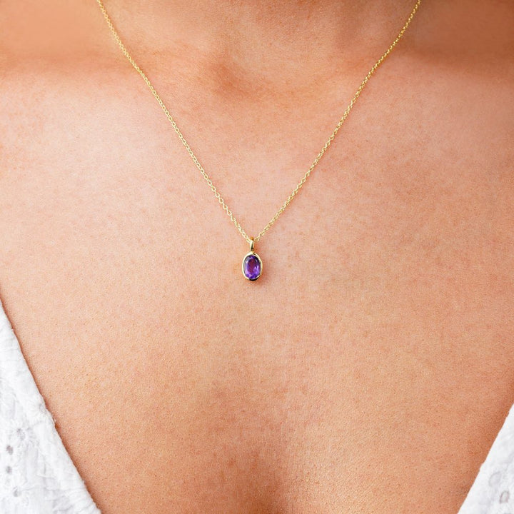Crystal jewelry with purple stone Amethyst in gold. Necklace with purple crystal Amethyst which is the birthstone of February.