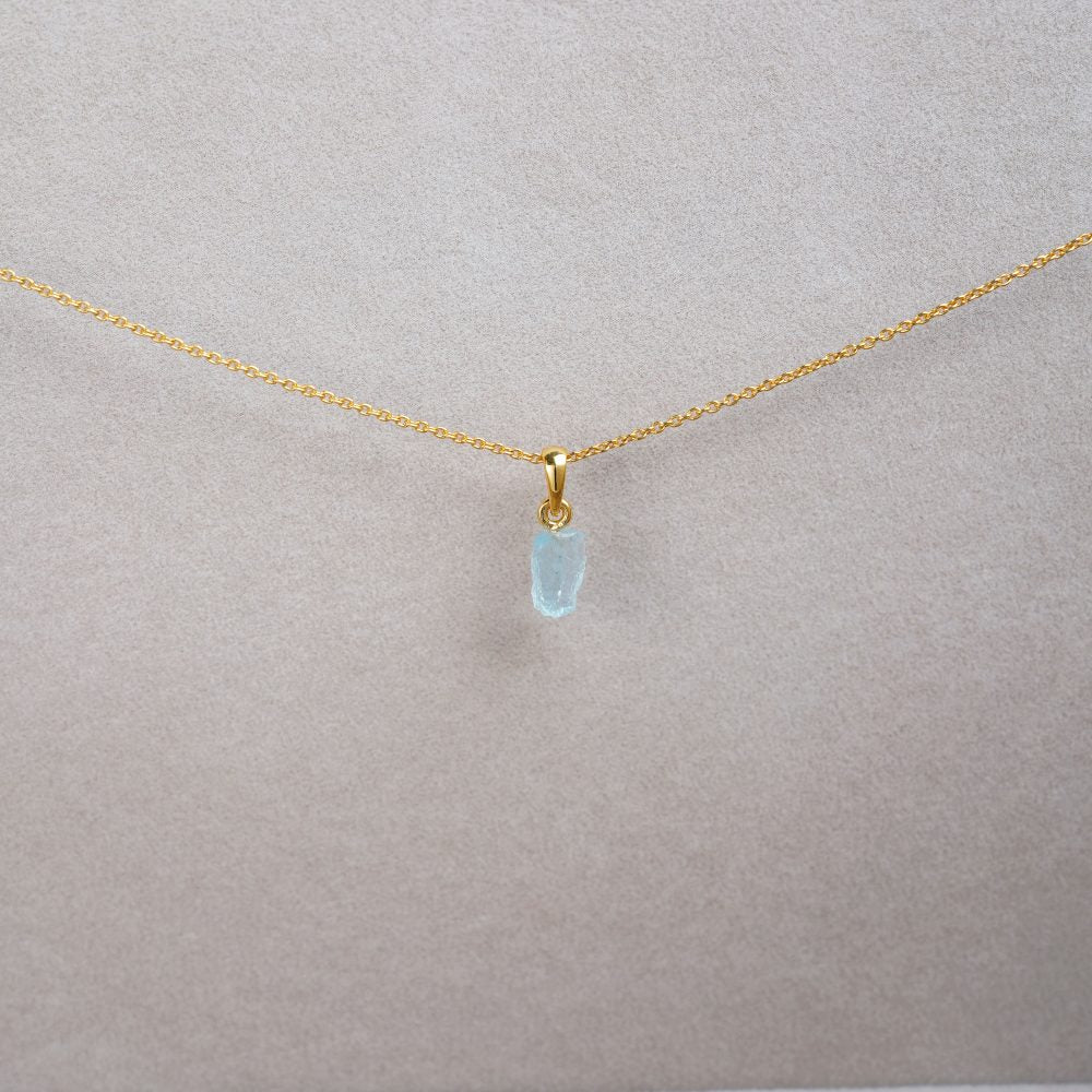 Crystal necklace with blue gemstone Aquamarine. Gold necklace with Aquamarine, which is a light blue crystal.