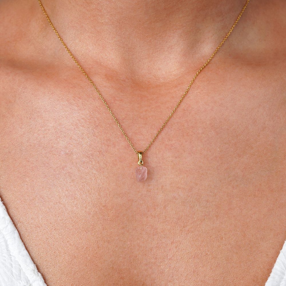 Raw Rose Quartz charm in gold. Petite and neat gemstone necklace with raw Rose quartz in gold.