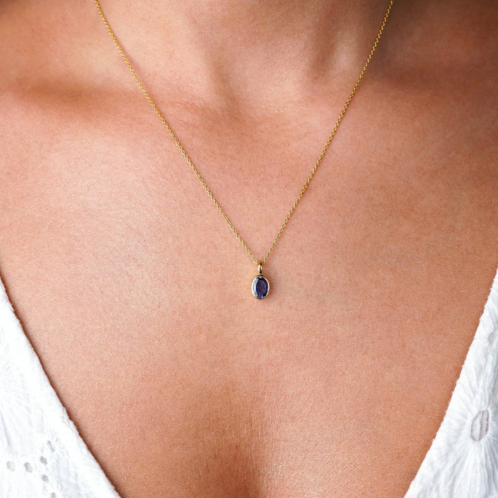 Crystal jewelry necklace in gold with crystal Iolite. Crystal necklace in gold with September birthstone Iolite.