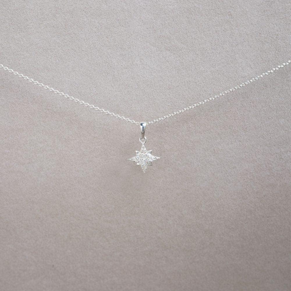 Silver necklace with a sparkly star. Crystal charm with genuine gemstones.