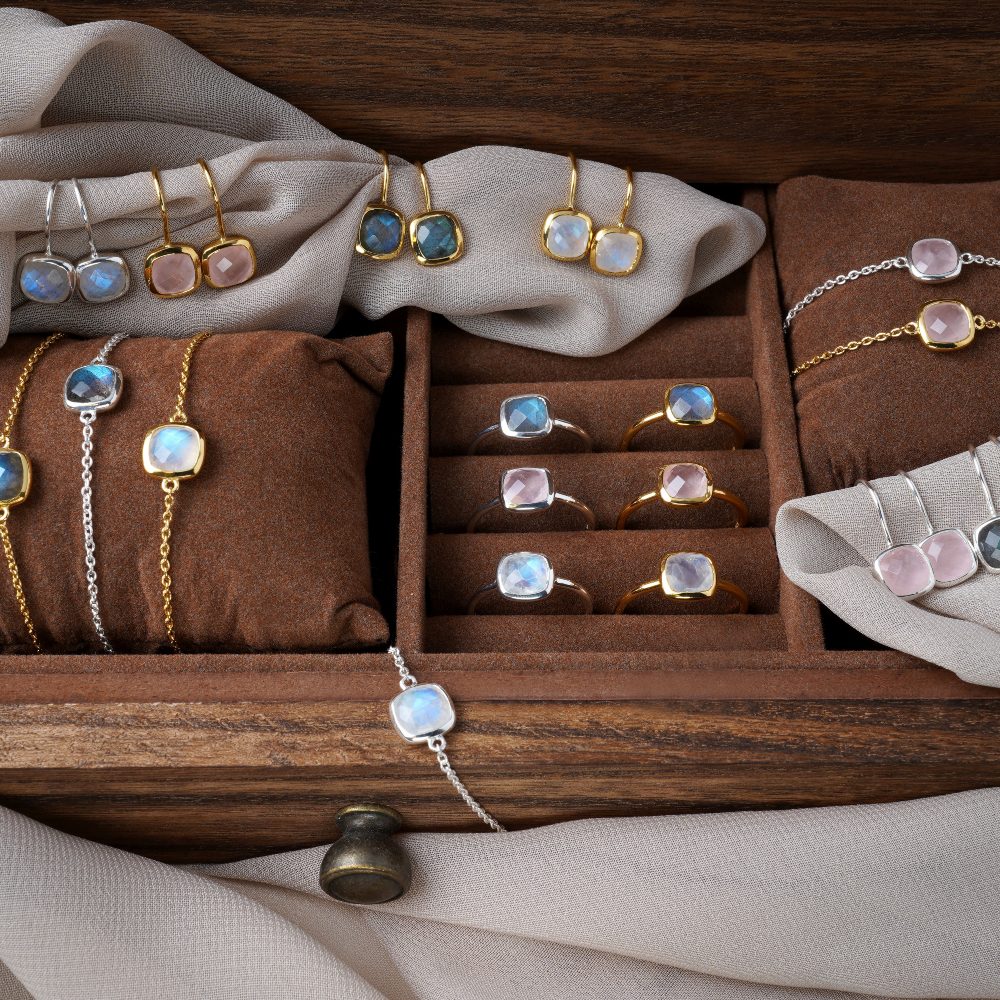 Dark oak box filled with elegant crystal jewelry. Magical jewelry box filled with gemstone jewelry, rings, earrings and bracelets. 