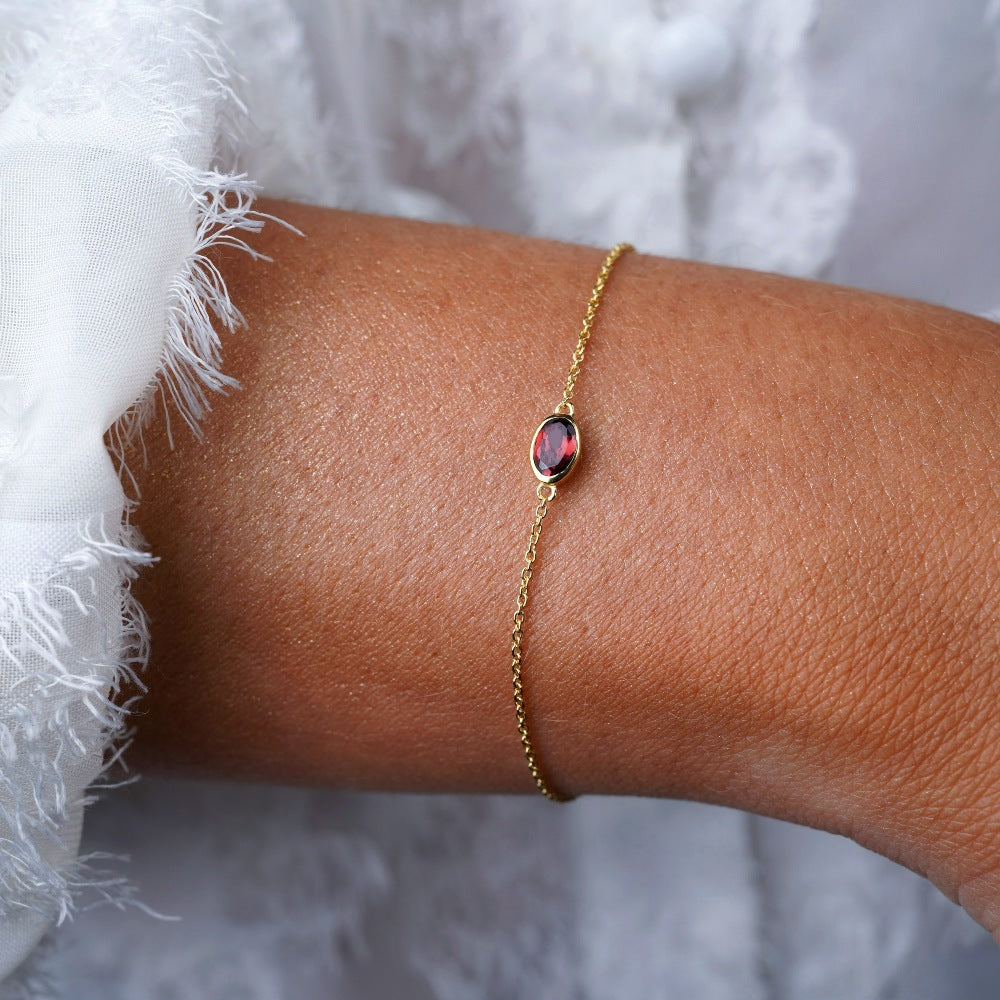 Gold bracelet with red crystal Garnet. Bracelet with January birthstone Garnet in gold.