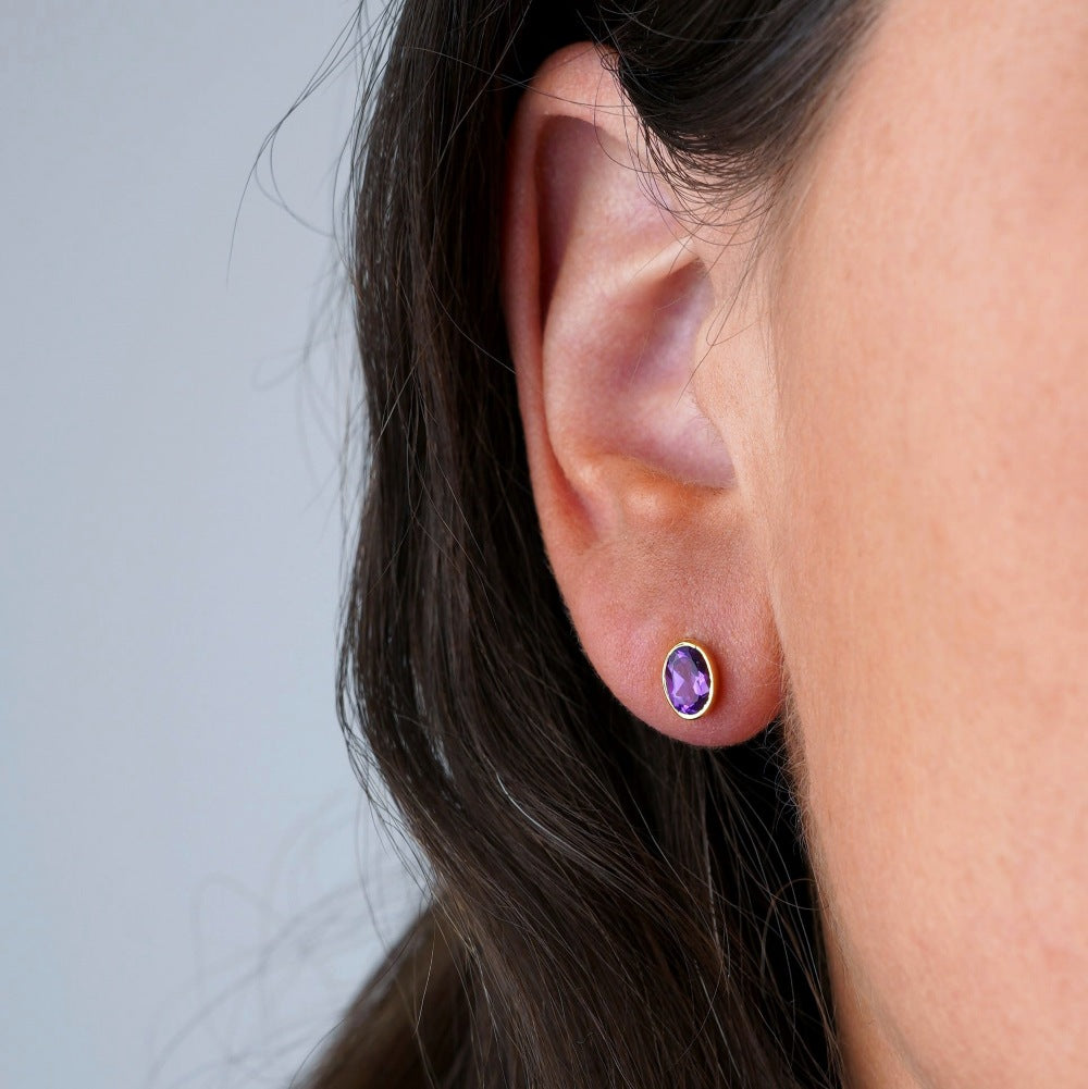 Amethyst earrings in gold. Birthstone February earrings in gold with purple crystal Amethyst.