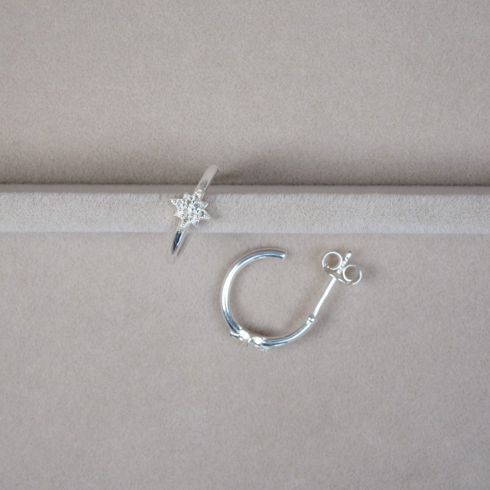 Hoops earrings in silver with sparkling star of White topaz crystals. Silver earrings with star and gemstones.