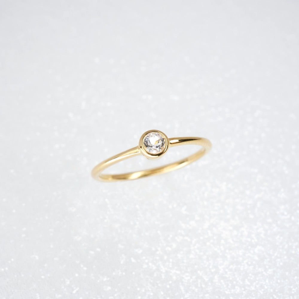 Gold ring with White topaz in a modern design. Elegant ring with gemstone White Topaz.