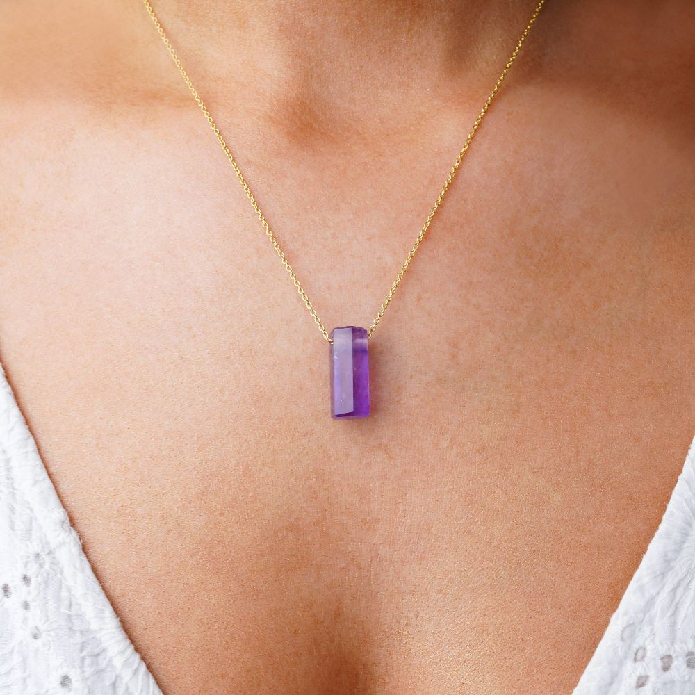Purple Amethyst crystal. Jewelry with Amethyst, which is the birthstone of February.