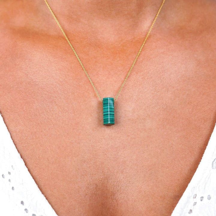 Necklace with green gemstone Malachite. Jewelry with green crystal that has a beautiful pattern.
