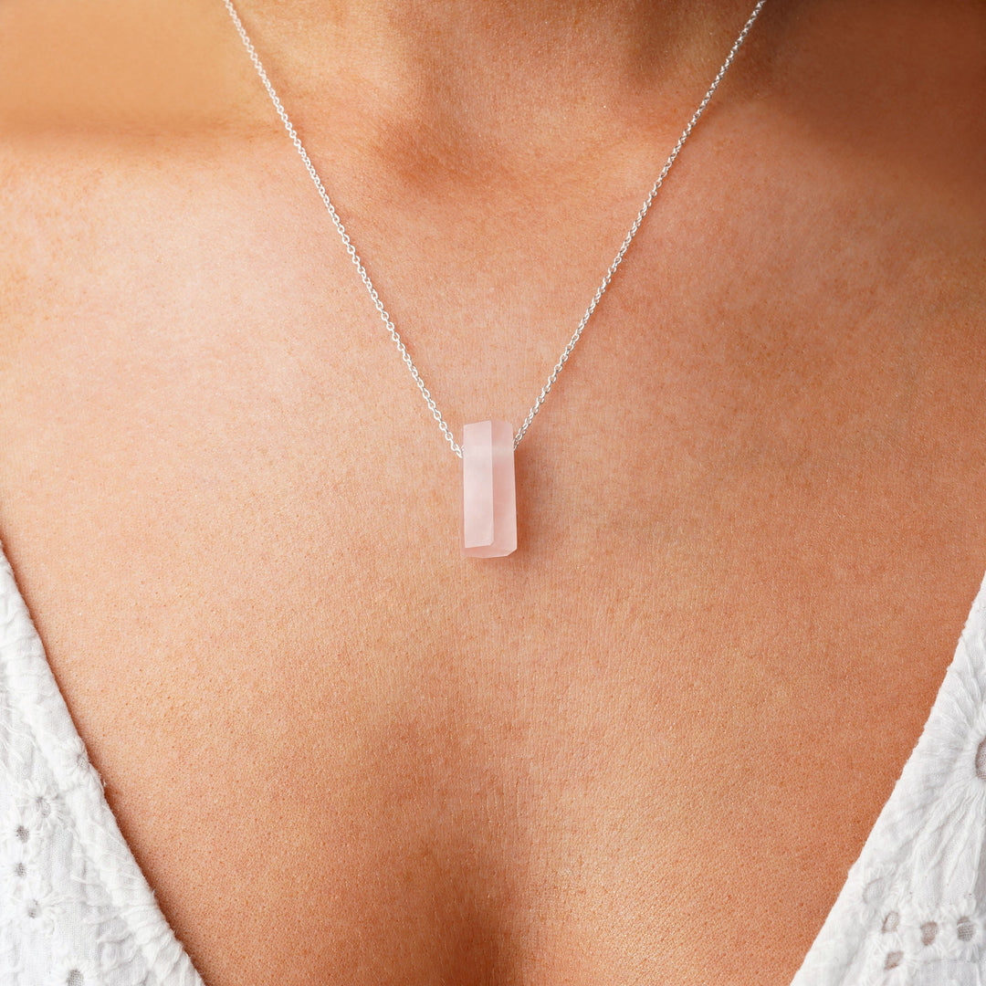 Silver necklace with polished Rose quartz gemstone. Crystal necklace with Rose quartz in a polished design.