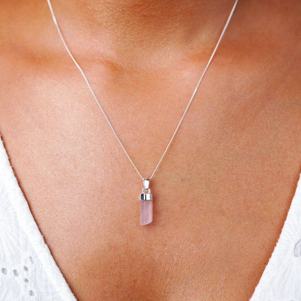 Rose quartz crystal point necklace in silver. Jewelry with pink gemstone Rose quartz in lace. Rose quartz is the stone of love and perfect to wear as a necklace close to your heart.