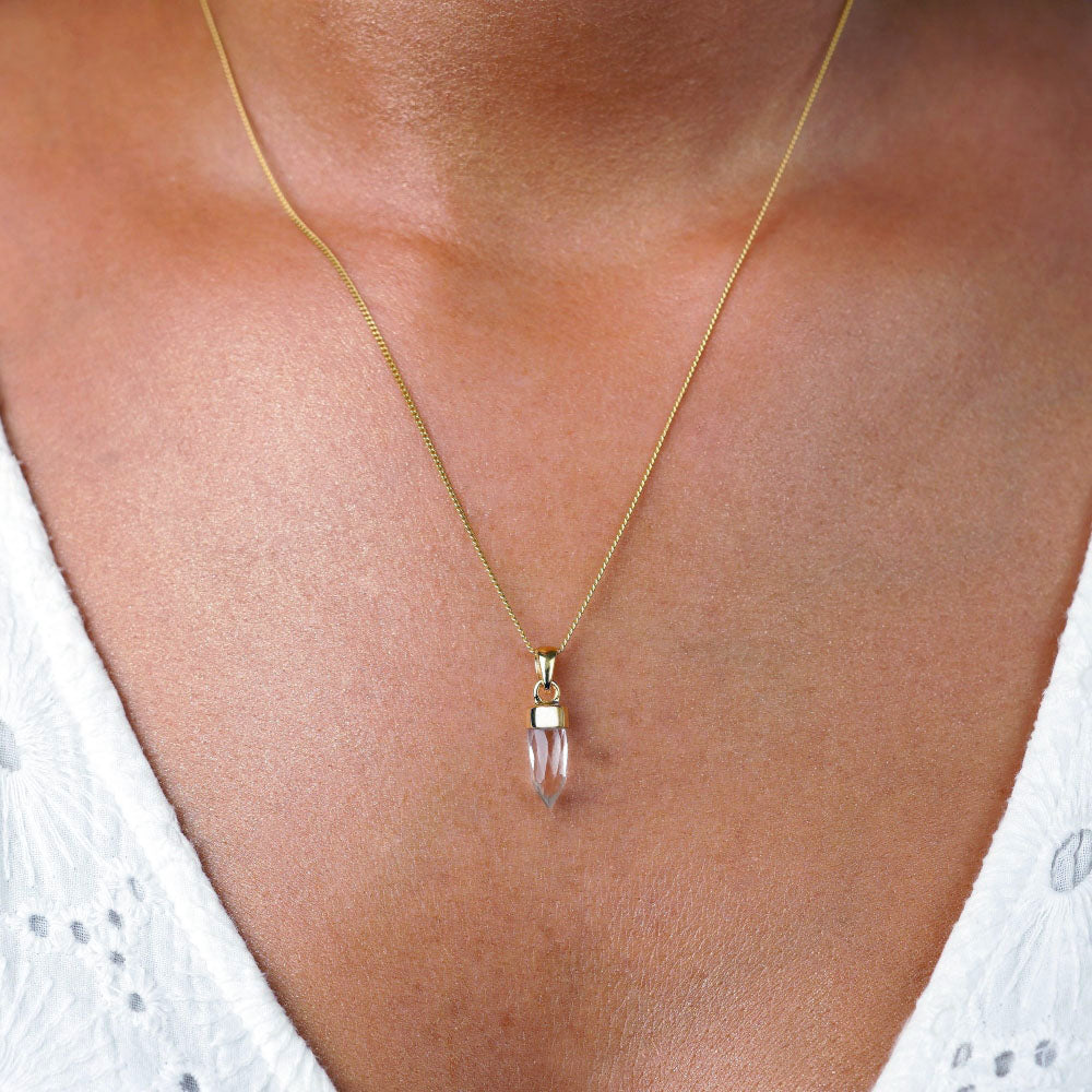 Clear Quartz mini point in gold to wear as a necklace. Clear Quartzl jewelry as mini point in gold perfect for necklaces.