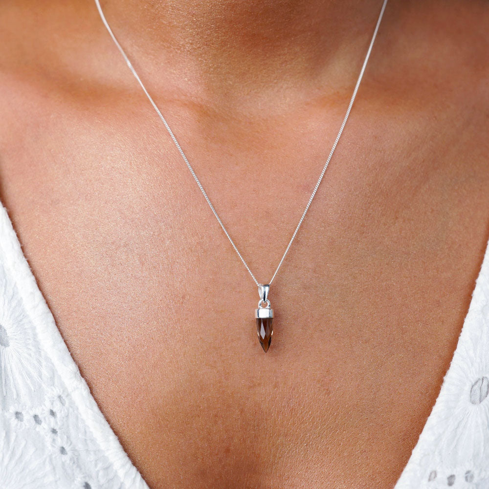 Smoky quartz jewelry shaped intp a mini point to wear in necklace. Gemstone charm with Smoky Quartz with silver details.