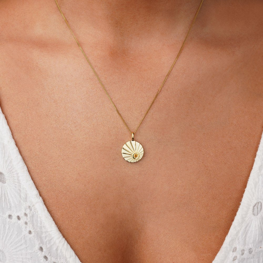 Coin necklace in gold with crystal yellow Citrine which stands for happiness. Jewelry with coin necklace in gold with sunset motif, sunset with crystal Citrine.