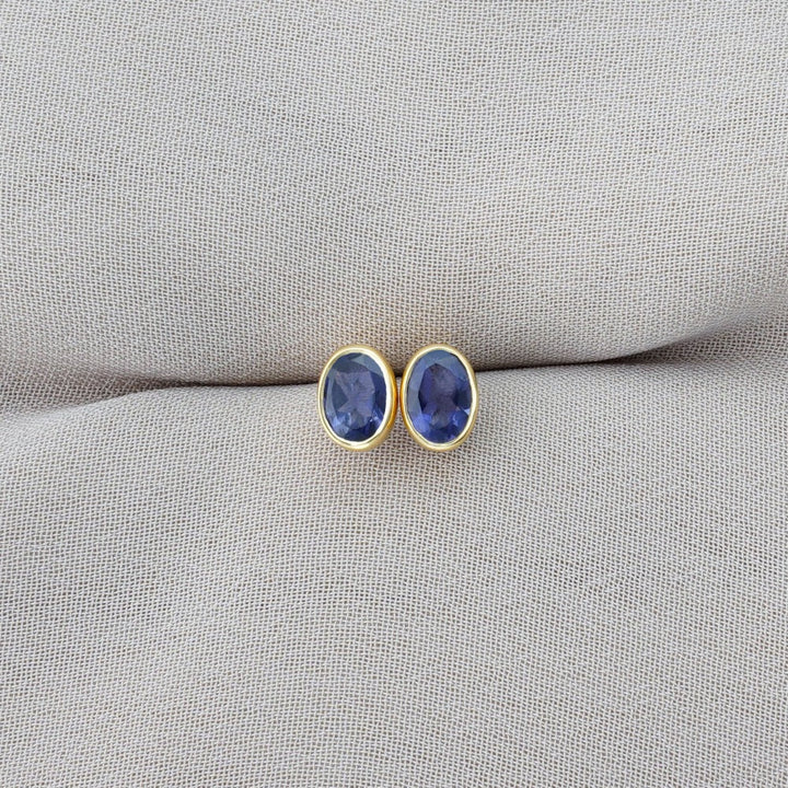 September birthstone earrings with Iolite. Gold earrings with blue crystal Iolite.