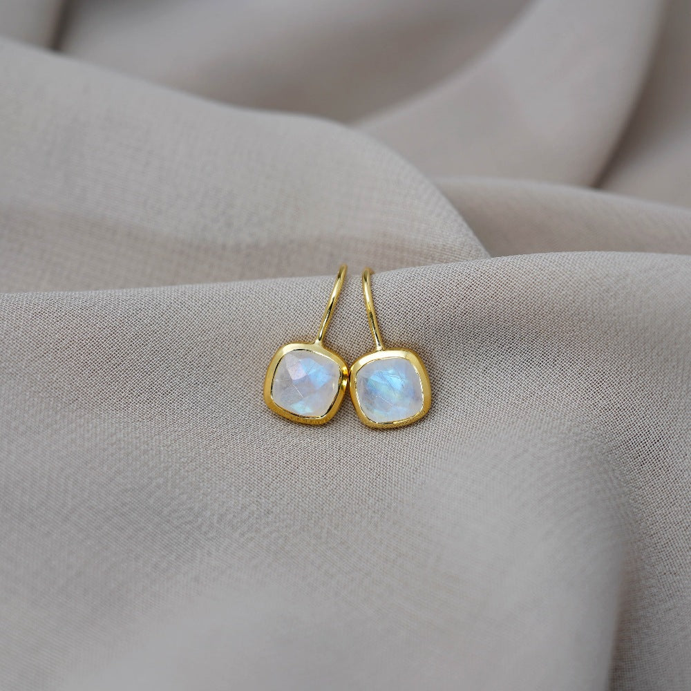 Elegant gold earrings with crystal Rainbow moonstone that shimmers blue. Magical crystal earrings with Moonstone, which is the birthstone of June.