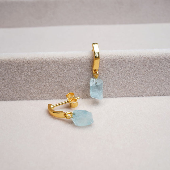 Modern crystal earrings in gold with blue crystal Aquamarine. Gold earrings with Aquamarine, which has a nice blue color.